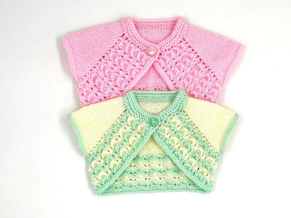 Two knitted baby boleros, one pink and one multicolored, knitted from DollieBabies knitting pattern 112 on a white background.