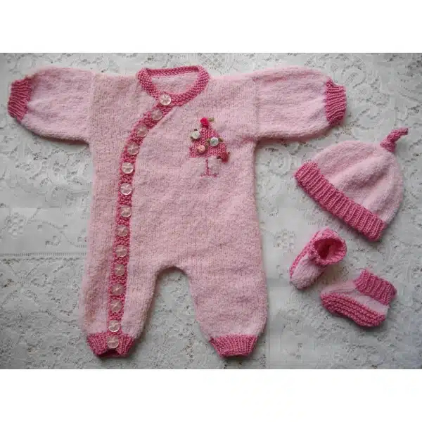 newborn knitting pattern for a side buttoning romper suit with tree motif