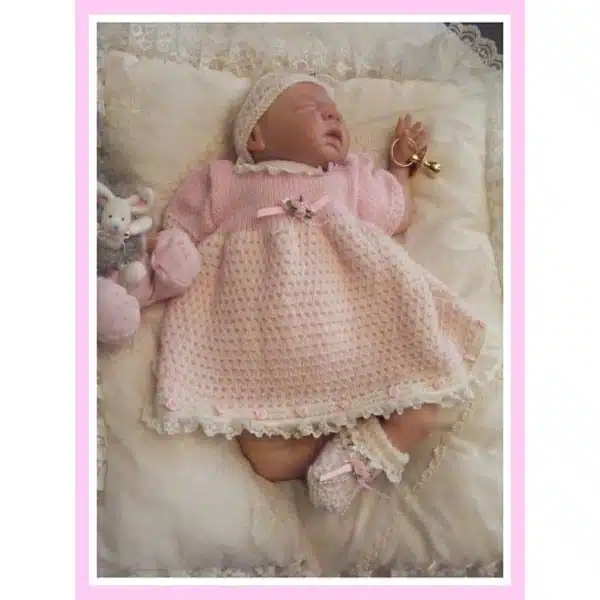 Newborn size baby dress knitted from knitting pattern 022